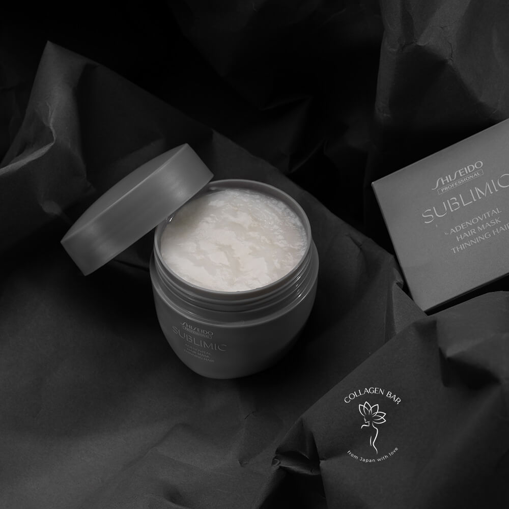 Відкрита банка SHISEIDO Adenovital Sublimic Hair Mask з коробкою на чорному тлі